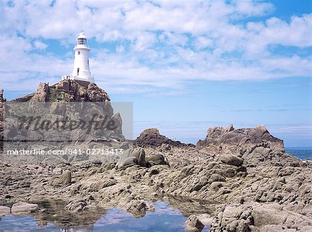 Lighthouse from the causeway at low tide, Corbiere, St. Brelade, Jersey, Channel Islands, United Kingdom, Europe