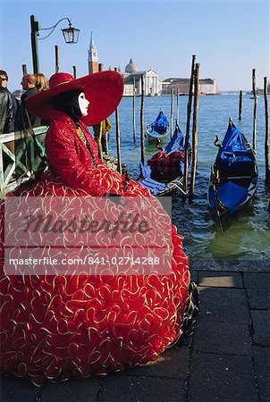 Person wearing masked carnival costume, San Giorgio in the background, Venice Carnival, Venice, Veneto, Italy