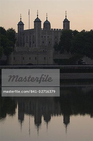 The Tower of London reflected in the calm water of the River Thames, London, England, United Kingdom, Europe