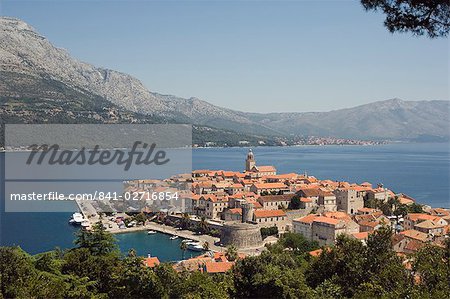 Hilltop view of red tile rooftops of medieval Old Town and Bay, Korcula Island, Dalmatia Coast, Croatia, Adriatic, Europe