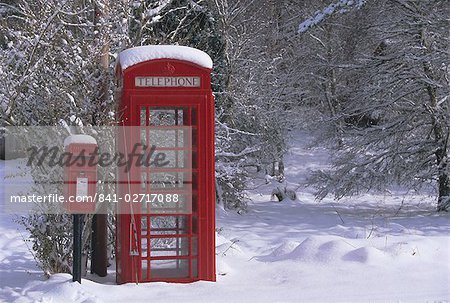 Red letterbox and telephone box in the snow, Highlands, Scotland, United Kingdom, Europe