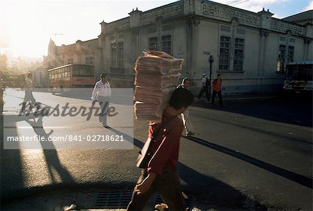 Morning activity on the streets, boy carrying newspapers, San Jose, Costa Rica, Central America