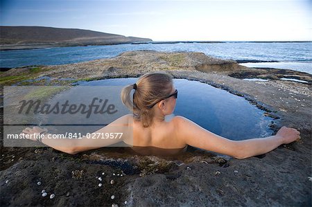 Young woman relaxing in a natural pool, Santa Cruz, Argentina, South America