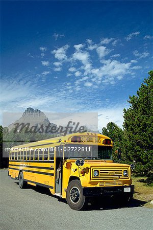 Yellow school bus, for students on geology field trip, Waterton Glacier International Peace Park, Rocky Mountains, Montana, United States of America, North America