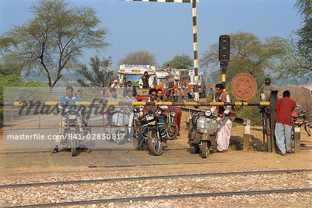 Traffic waiting at railway crossing, India, Asia