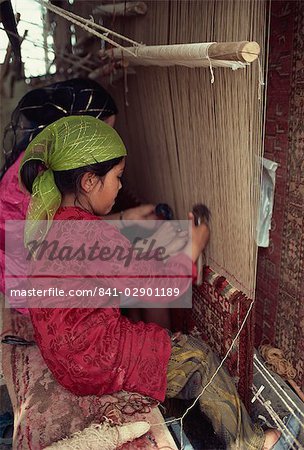 Uyghur children learning to make carpets, Hotan, China, Asia