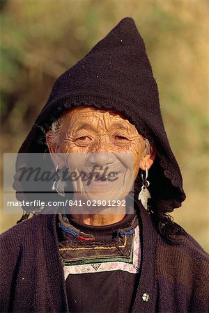 Portrait of an old Miao woman in a black woollen hood in central Guizhou, China, Asia