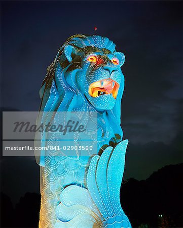 The Merlion statue, the symbol of Singapore, in turquoise light at night in Singapore, Southeast Asia, Asia