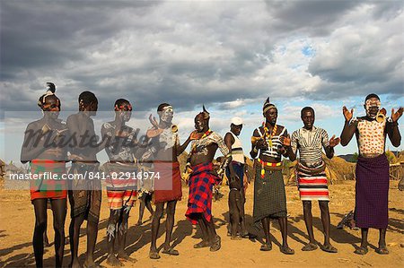 Karo people with body painting, made from mixing animal pigments with clay, dancing, Kolcho village, Lower Omo valley, Ethiopia, Africa