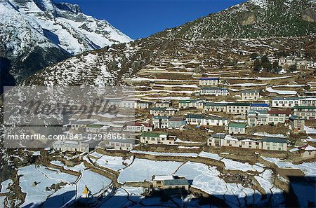 Houses and terraced fields under snow at Namche Bazaar in the Himalayas in Nepal, Asia