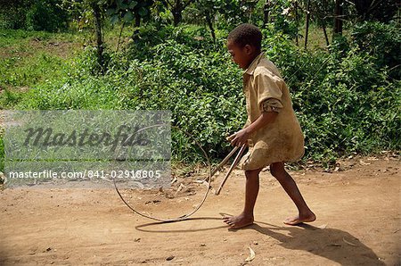 Boy playing with hoop, Kabale, Uganda, Africa