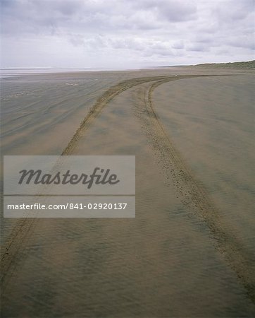 Car tracks along 90 Mile Beach, officially designated a road, in Northland, North Island, New Zealand, Pacific