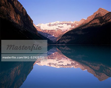 View to Mount Victoria across the still waters of Lake Louise, at sunrise, Banff National Park, UNESCO World Heritage Site, Alberta, Canada, North America