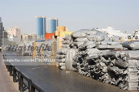 Goods stacked on the dockside of the Dhow Wharfage awaiting transportation by dhow to ports throughout the Middle East, India and Asia, Dubai Creek, Dubai, United Arab Emirates, Middle East