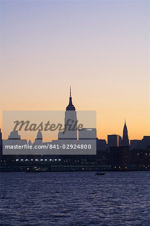 Empire State Building and Midtown Manhattan skyline at sunrise, New York City, New York, United States of America, North America Empire State Building and Midtown Manhattan skyline at sunrise, New York City, New York, United States of America, North America