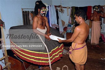 Kathakali dancer dressing in costume, Kerala state, India, Asia