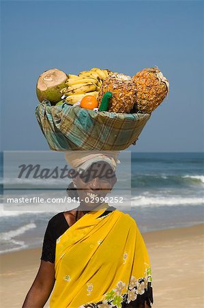 Fruit vendor on beach near the Leela Hotel, Mobor, Goa, India, Asia
