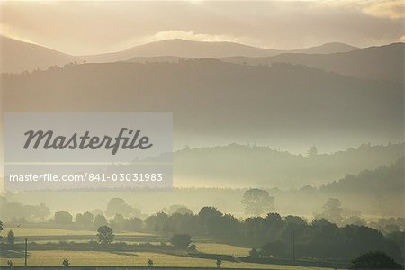 View of hills and landscape in early morning mist, River Derwent Valley, Lake District, Cumbria, England, United Kingdom, Europe