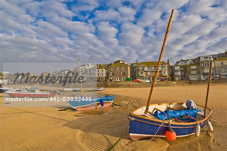 Strange cloud formation in the early morning with small Cornish fishing boats at low tide in the harbour at St. Ives, Cornwall, England, United Kingdom, Europe Strange cloud formation in the early morning with small Cornish fishing boats at low tide in the harbour at St. Ives, Cornwall, England, United Kingdom, Europe