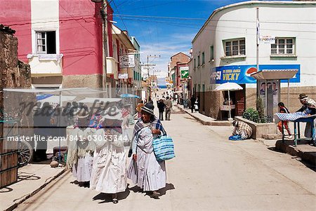Women walking down street, Copacabana, LakeTiticaca, Bolivia, South America