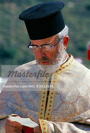 Portrait of a Greek Orthodox priest praying during Lambri Triti festival, Olymbos (Olimbos), Karpathos, Dodecanese islands, Greece, Mediterranean, Euope