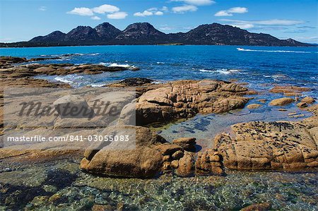 Lichen covered red granite rocks at the Hazards Mountain Range, Coles Bay, Freycinet Peninsula, Freycinet National Park, Tasmania, Australia, Pacific