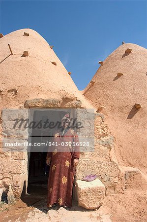 Local woman in front of her beehive house built of brick and mud, Srouj village, Syria, Middle East