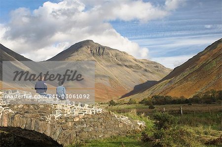 Two walkers resting, looking to Great Gable 2949ft, Wasdale Valley, Lake District National Park, Cumbria, England, United Kingdom, Europe