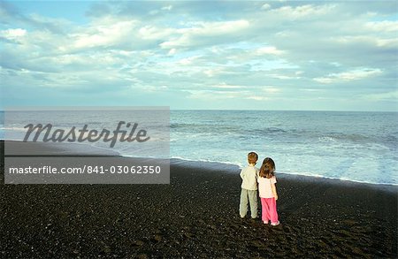 Two young children, boy and girl, on the beach at Napier, North Island, New Zealand, Pacific