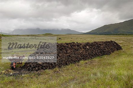 Cut peat stacked up for winter, Connemara, County Galway, Connacht, Republic of Ireland, Europe