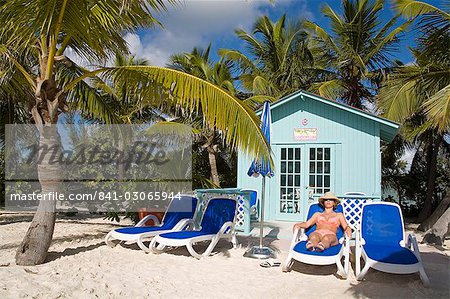 Beach cabana and woman, Princess Cays, Eleuthera Island, Bahamas, West Indies, Central America