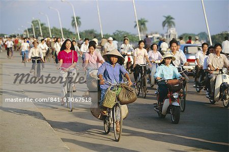 Cyclists in morning rush hour on Phu Xuan bridge, Hue, Vietnam, Indochina, Southeast Asia, Asia