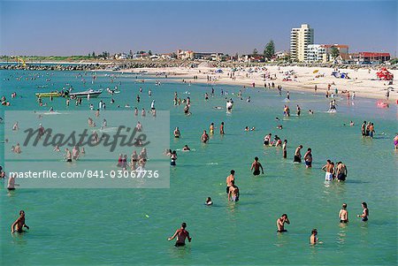 Groups of people in the sea and on the beach at Glenelg, a resort suburb of Adelaide, where first South Australian colonists landed, South Australia, Australia, Pacific