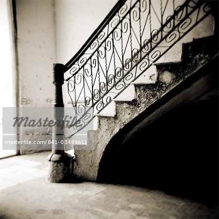 Image taken with a Holga medium format 120 film toy camera of stairs with ornate ironwork inside apartment building, Cienfuegos, Cuba, West Indies, Central America