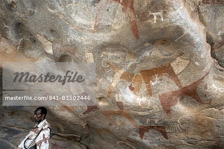 A Somaliland soldier stands guard at the 5000 year-old cave paintings in Lass Geel caves, Somaliland, northern Somalia, Africa