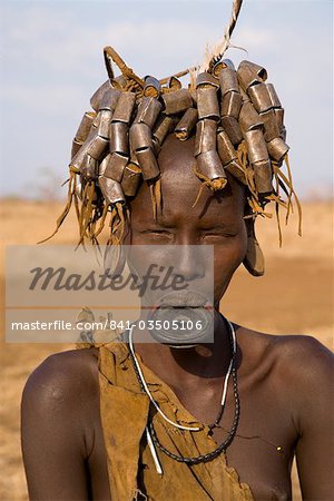 Portait of a Mursi girl with clay lip plate, and hairstyle that indicates she is going through puberty,The Mursi Hills, Mago National Park, Lower Omo Valley, Ethiopia, Africa