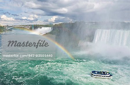Maid of the Mist tour excursion boat under the Horseshoe Falls waterfall with rainbow at Niagara Falls, Ontario, Canada, North America