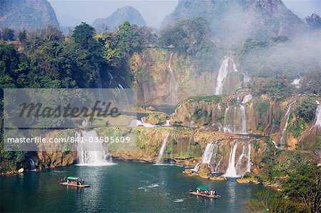 Tourist boats beneath Detian Falls, China and Vietnam transnational waterfall, Guangxi Province, China, Asia