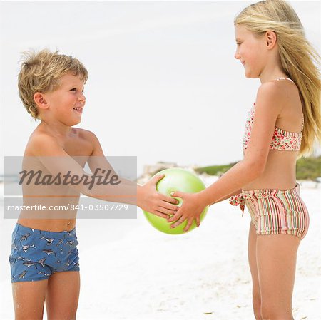 Boy and girl (6-8) on beach playing with ball - Stock Photo - Masterfile -  Rights-Managed, Artist: robertharding, Code: 841-03507729