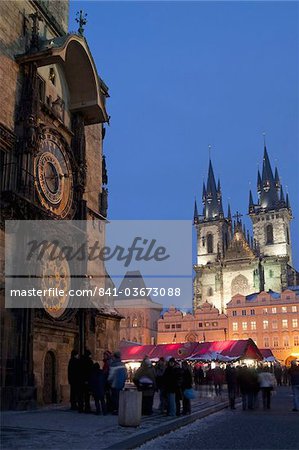 Astronomical Clock of Gothic Old Town Hall, stalls of Christmas Market, and Gothic Tyn Church, at twilight, Old Town Square, Stare Mesto, Prague, Czech Republic, Europe