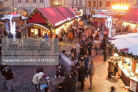 Stalls and people at Christmas Market at dusk, Old Town Square, Stare Mesto, Prague, Czech Republic, Europe