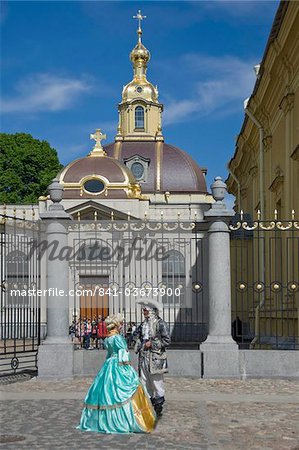 Two people in period dress by the Cathedral, Peter and Paul Fortress, St. Petersburg, Russia, Europe