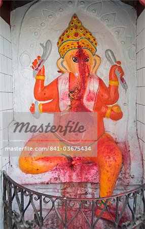 Temple shrine to Ganesh, the elephant god, daubed by pilgrims with red powder, at the entrance to Sri Mahabhairab Mandir, Tezpur, Assam, India, Asia
