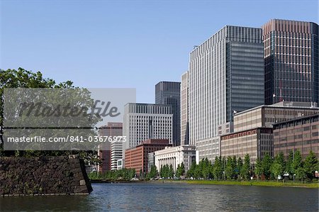 Modern high-rise office buildings lining the old Edo Castle moat in the Marunouchi district of Tokyo, Japan, Asia