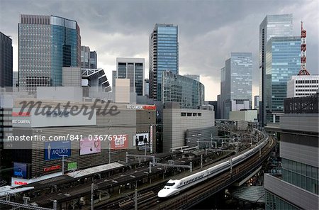 Shinkansen bullet train weaving through maze of buildings in the Yurakucho district of downtown Tokyo, Japan, Asia