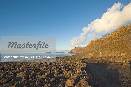 Spectacular 600m volcanic cliffs of the Risco de Famara and Graciosa Island at the northern end of Lanzarote's finest beach at Famara, Lanzarote, Canary Islands, Spain, Atlantic Ocean, Europe