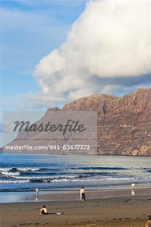 Spectacular 600m volcanic cliffs of the Risco de Famara rising over island's finest surf beach in the north west of the island, Famara, Lanzarote, Canary Islands, Spain, Atlantic Ocean, Europe
