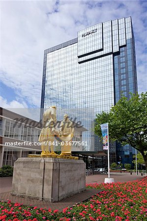 Statue of Boulton, Watt and Murdoch, nicknamed The Golden Boys or The Carpet Salesmen  by William Bloye, with Hyatt Hotel from Centenary Square, Birmingham city centre, West Midlands, England, United Kingdom, Europe