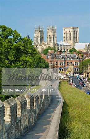 York Minster, northern Europe's largest Gothic cathedral, and a section of the historic city walls along Station Road, York, Yorkshire, England, United Kingdom, Europe