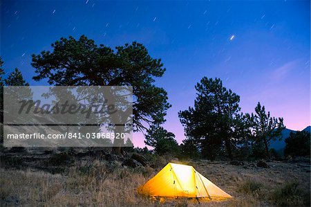 Tent illuminated under the night sky, Rocky Mountain National Park, Colorado, United States of America, North America
